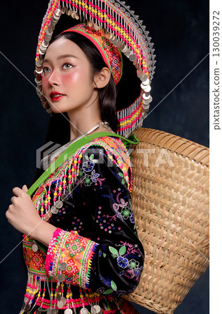 Beautiful Asian woman wearing traditional colorful ethnic costume and silver jewelry, posing in studio portrait. Cultural fashion photography showcasing vibrant embroidery, handmade textile. Beautiful Asian woman wearing traditional colorful ethnic costume and silver jewelry, posing in studio portrait. Cultural fashion photography showcasing vibrant embroidery, handmade textile. 130039272