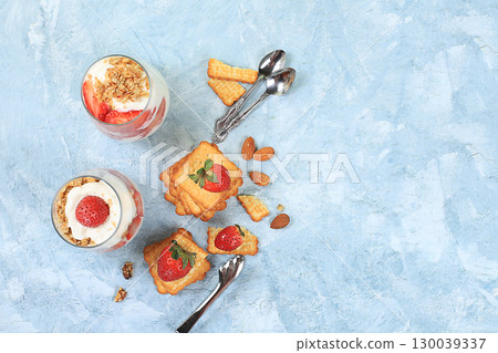 Strawberry yogurt with berries, French cracker and muesli on a bright table, fruit salad. Healthy breakfast with ingredients, natural food concept, lifestyle, food for children, selective focus, place Strawberry yogurt with berries, French cracker and muesli on a bright table, fruit salad. Healthy breakfast with ingredients, natural food concept, lifestyle, food for children, selective focus, place 130039337