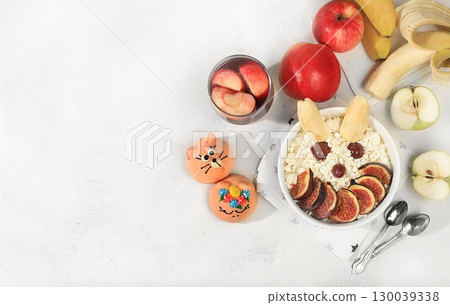 Healthy breakfast with ingredients, fun food for kids. Cottage cheese with figs and bananas, apples and grapes, top view, Healthy and natural food concept. selective focus. Healthy breakfast with ingredients, fun food for kids. Cottage cheese with figs and bananas, apples and grapes, top view, Healthy and natural food concept. selective focus. 130039338