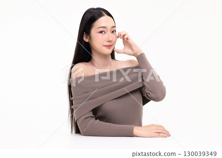 Portrait of young Asian beautiful woman with K-beauty make up style and healthy and perfect skin make heart shape hand signal isolated on white background for skincare commercial product advertising. 130039349