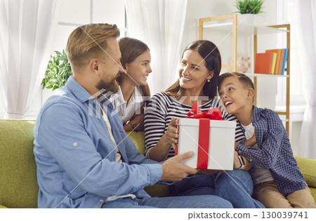 Happy woman receives beautiful present from husband and children on Mother's Day 130039741