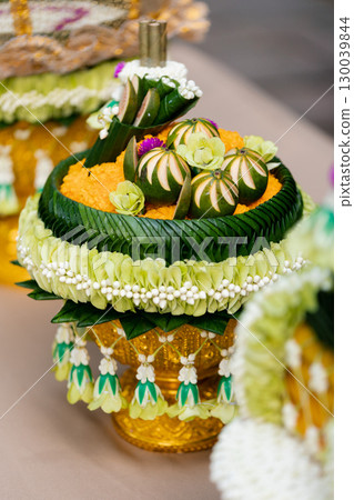 offerings in the traditional Thai wedding procession Khan Mak ceremony arrangements displayed on a table in a lush garden setting offerings in the traditional Thai wedding procession Khan Mak ceremony arrangements displayed on a table in a lush garden setting 130039844