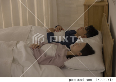 Couple sleeping in bedroom Couple sleeping in bedroom 130040318