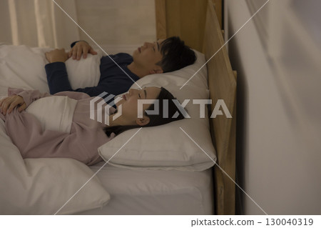 Couple sleeping in bedroom Couple sleeping in bedroom 130040319