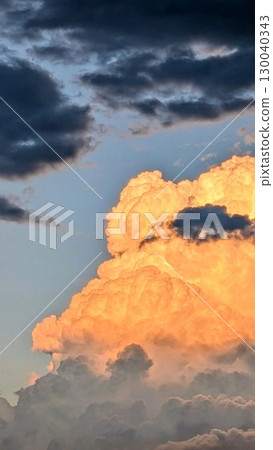 Cumulonimbus clouds illuminated by the setting sun [Summer] 130040343