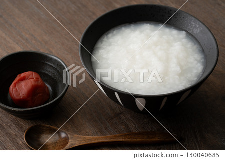 Pickled plums and rice porridge in a bowl 130040685