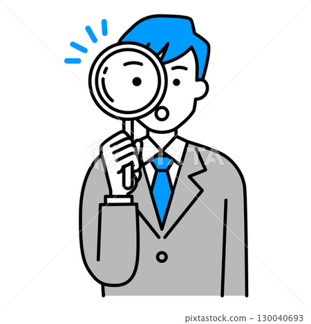 A man in a suit looking through a magnifying glass 130040693