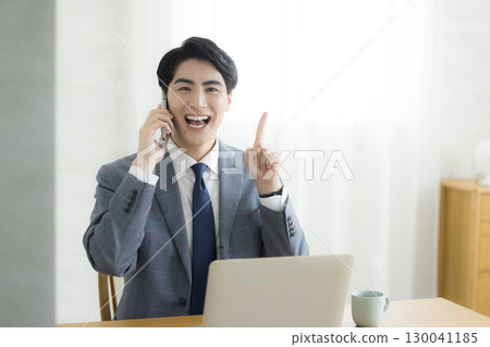 A man talking on a smartphone A man talking on a smartphone 130041185