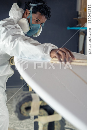 Shaper working on surf board 130041211