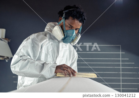 Shaper working on surf board 130041212