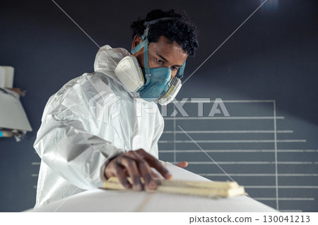 Shaper working on surf board 130041213