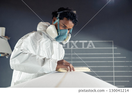 Shaper working on surf board 130041214