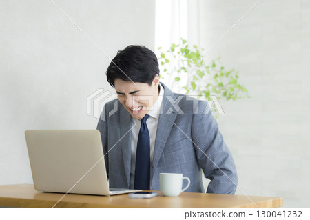 Businessman holding his head Businessman holding his head 130041232