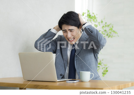 Businessman holding his head Businessman holding his head 130041235
