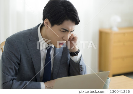 Businessman holding his head Businessman holding his head 130041236