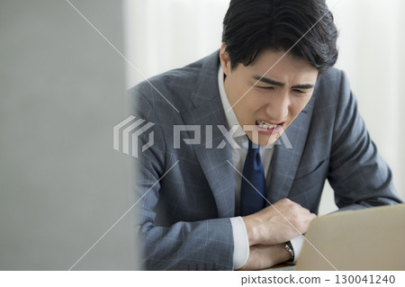 Businessman holding his head 130041240