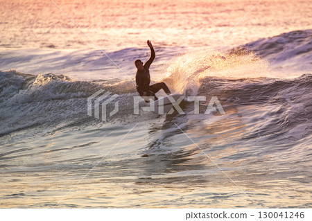 Sporty boy riding his surf board 130041246