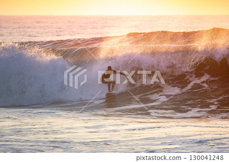 Sporty boy riding his surf board 130041248
