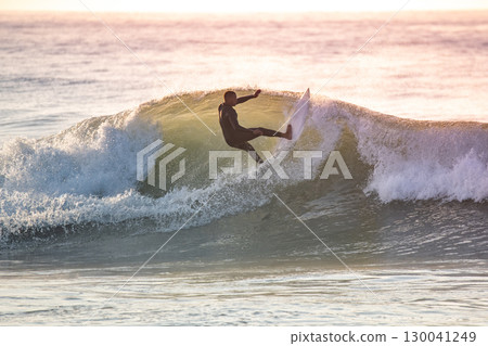 Young surfer enjoying waves Young surfer enjoying waves 130041249