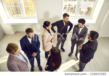 Group of happy young people meeting and communicating at a modern business event 130041985