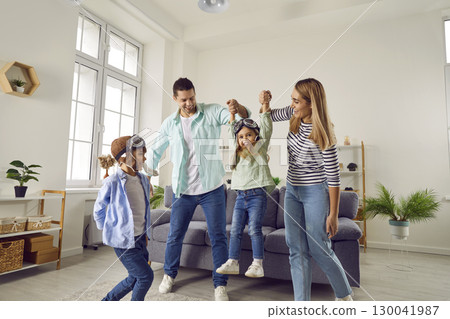 Carefree cheerful parents, son and daughter playing at home 130041987