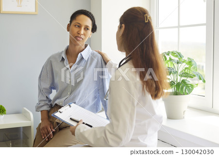 Female doctor therapist talking with her patient in office. Medicine and support concept. Female doctor therapist talking with her patient in office. Medicine and support concept. 130042030