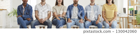 Cropped shot of multiethnic group of job applicants sitting in row 130042060