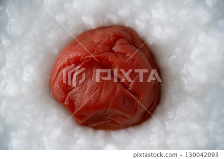 Close-up of pickled plums on rice porridge 130042093