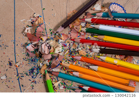 Colored pencils creating colorful shavings on cardboard Colored pencils creating colorful shavings on cardboard 130042116