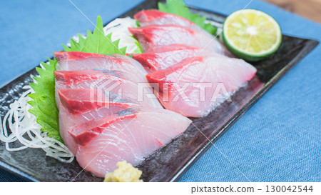Japanese dish of yellowtail sashimi with daikon radish and sudachi citrus 130042544