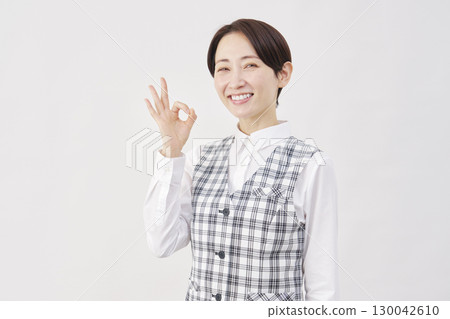 Female office worker OK sign white background Female office worker OK sign white background 130042610