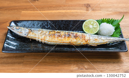 Japanese dish of grilled salted saury with grated daikon radish and sudachi citrus 130042752