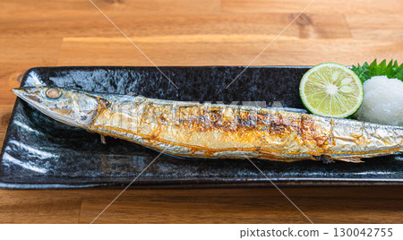Japanese dish of grilled salted saury with grated daikon radish and sudachi citrus Japanese dish of grilled salted saury with grated daikon radish and sudachi citrus 130042755