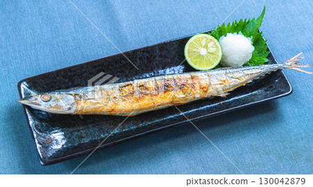 Japanese dish of grilled salted saury with grated daikon radish and sudachi citrus 130042879