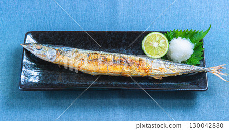 Japanese dish of grilled salted saury with grated daikon radish and sudachi citrus 130042880