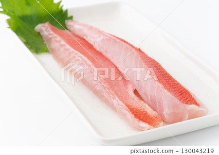 A boiled alfonsino on a square plate on a white background 130043219