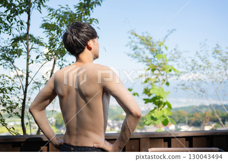 Man relaxing in the open-air bath Man relaxing in the open-air bath 130043494