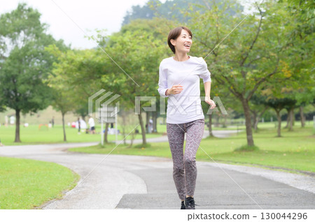 A woman running a park 130044296
