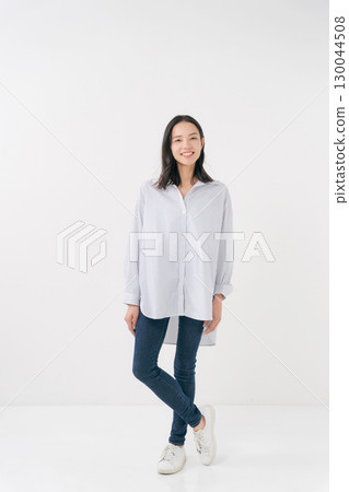 Smiling woman in casual shirt and jeans Smiling woman in casual shirt and jeans 130044508