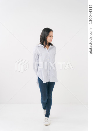 穿著休閒襯衫和牛仔褲的微笑女人 130044515