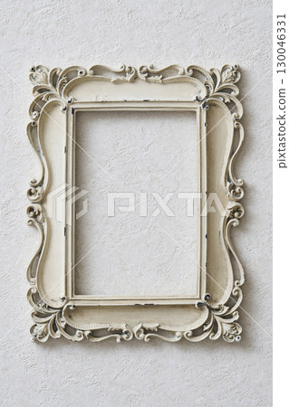Antique frame hanging on a white wall Antique frame hanging on a white wall 130046331