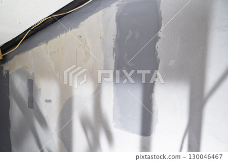 Closeup view of an unfinished gray painted wall during home renovation. Home renovation project 130046467