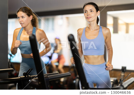 Woman exercising on a treadmill in the gym 130046636