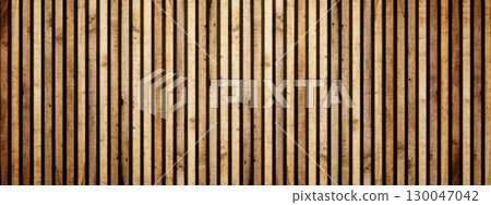 Closeup view of textured wooden slats background. Decorative brown wood paneling with vertical stripes, showing natural wood grain and texture. Wood texture background 130047042
