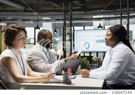 Candidate and the hiring team in a recruiting meeting discussing interview questions and the opportunity for onboarding into the department workforce. Experience evaluation, head hunting. 130047244