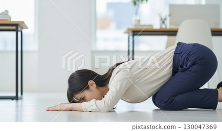 Businesswoman kneeling down Businesswoman kneeling down 130047369