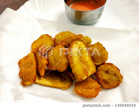 Banana Fritters Served with Spicy Red Chutney 130048058