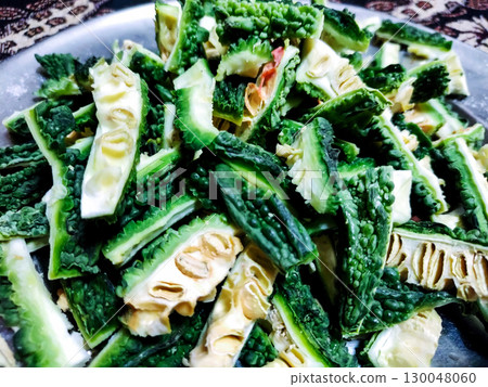 Sliced Bitter Gourd (Karela) in a Steel Plate Sliced Bitter Gourd (Karela) in a Steel Plate 130048060