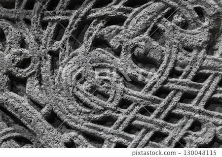 Detailed view of a stone carving showcasing complex and intricate Celtic knot 130048115