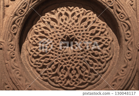 Elaborately carved ancient circular design featuring symmetric patterns, Armenia Elaborately carved ancient circular design featuring symmetric patterns, Armenia 130048117